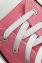 Lacing on a retro sneaker, close-up, on a blue wooden background