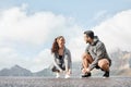 Lacing up before clocking some miles. a sporty young man and woman tying their shoelaces while exercising outdoors. Royalty Free Stock Photo