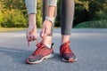 Lacing up running shoes. Close-up of woman hands that lace up tr Royalty Free Stock Photo