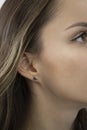 Lack of earlobe. A beautiful woman with an ingrown earlobe. The face of a beautiful girl close-up. Her earlobe is Royalty Free Stock Photo