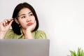 Asian woman office worker sitting at desk with no motivation for work