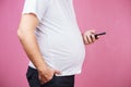 Lack of physical activity, fat man with smartphone Royalty Free Stock Photo