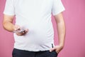 Lack of physical activity, fat man with smartphone Royalty Free Stock Photo