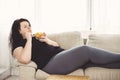 Fat woman overeating junk food. sedentariness Royalty Free Stock Photo