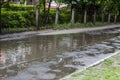 A huge muddy puddle in the courtyard of a residential building. Sleeping area of the city, old houses, cheap housing