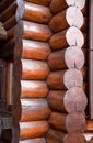 Lackered Warm corner of a log wooden blockhouse, close-up. Wooden house construction, architecture