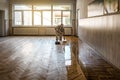 Lacquering parquet floors. Professional worker uses a roller to coating floors. Varnish Royalty Free Stock Photo