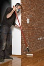 Lacquering wood floors. Worker uses a roller to coating floors Royalty Free Stock Photo