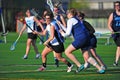 Lacrosse girls defending the goal