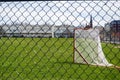 A lacrosse goal on a grass field in Porlanad, Maine