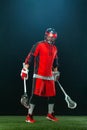 Lacrosse Player, athlete sportsman in red helmet on dark background. Sport and motivation wallpaper.