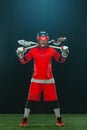 Lacrosse Player, athlete sportsman in red helmet on dark background. Sport and motivation wallpaper.