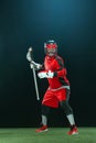 Lacrosse Player, athlete sportsman in red helmet on dark background. Sport and motivation wallpaper.