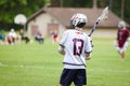 Lacrosse player in the green field in action