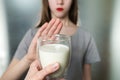 Lactose intolerance. Dairy Intolerant young girl refuses to drink milk Royalty Free Stock Photo