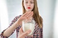 Lactose intolerance. Dairy Intolerant young girl refuses to drink milk Royalty Free Stock Photo