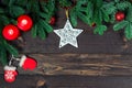 Lacy star, a pair of candles and fir branches on wooden boards, space for congratulations