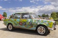 a Lada zhiguli painted in hippie style on sunny day