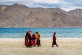 Group of Little buddhist monks wearing Covid mask near beautiful Pangong lake