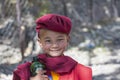 Happy young buddhist monk during Hemis Festival at Ladakh, North India, close up portrait