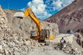 Excavator cleaning road after landslide in Himalayas