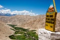 Green Valley in arid Ladakh with a milestone