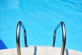 Ladder in the blue swimming pool Royalty Free Stock Photo
