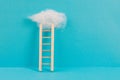 Ladder with a cloud on top, pink rose colored background, copy space, dreaming of success, creative and business concept