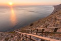 Ladder going down to the sea on a rocky cliff, sunset, Anapa, Russia