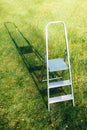 Ladder on green lawn background Royalty Free Stock Photo