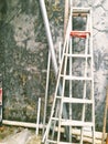 ladder made of aluminum that leans against the front wall of the house Royalty Free Stock Photo