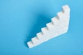 Ladder made of sugar on a blue background Royalty Free Stock Photo