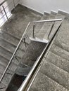 Ladder march made of concrete with stainless steel handrails. With stains of whitewash and paint after repair.