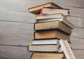Ladder on pile of old books on wooden background Royalty Free Stock Photo