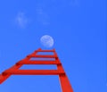 Ladder red up to moon isolated in blue background - 3d rendering Royalty Free Stock Photo