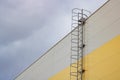 Ladder to the roof of a tall building on a dark sky background Royalty Free Stock Photo