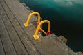 Ladder into the water of the little harbor of the marina of Sopot, Poland, with moored boat and yachts. Royalty Free Stock Photo