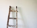 A ladder on a white wall