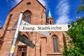 Ladenburg, Germany, Direction sign leading to Protestant church called `Evangelische Stadtkirche` in front catholic `St. Gallus` c