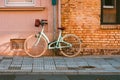 A ladies bike in a city in front of a house