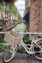 Ladies bike parked on a bridge over the Voldersgracht in the old center of Delft in the Netherlands