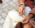 Ladies are demonstrating sewing and decorating of clothes by embroidery frame for students in housework class