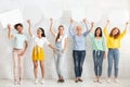 Ladies Holding Empty Speech Bubbles Standing Over White Wall Indoors