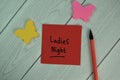 Ladies Night write on sticky notes isolated on Wooden Table