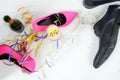 ladies pink high heela and black mens shoes lying between champagne and streamers, concept for a wild party from above Royalty Free Stock Photo