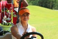 Ladies pro golfer Carly Booth behind steering wheel of golf cart Royalty Free Stock Photo