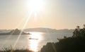 At sunset a rowing gig crosses the still silver waters off Tresco, isles of Scill,y Engla