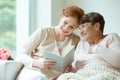 Ladies sitting on the couch Royalty Free Stock Photo