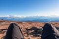 Ladinger Spitz - Hiker man legs resting on alpine meadow with panoramic view on mountains seen from Ladinger Spitz, Saualpe Royalty Free Stock Photo