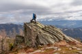 Ladinger Spitz - Man with a hiking backpack on a massive rock on summit Gertrusk on the way near Ladinger Spitz, Saualpe Royalty Free Stock Photo